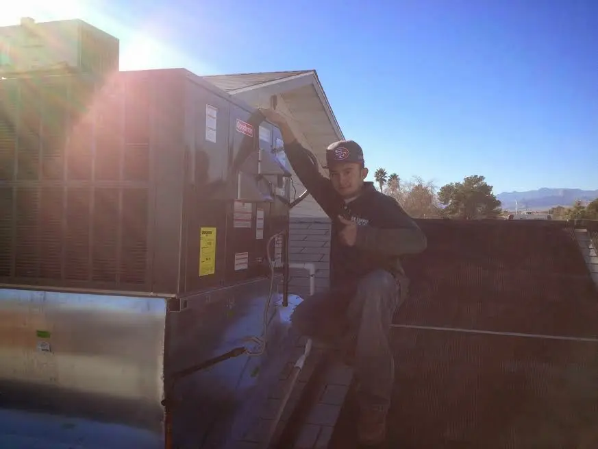 HVAC technician performing Heat Pump Repair on a rooftop unit in Clarksville